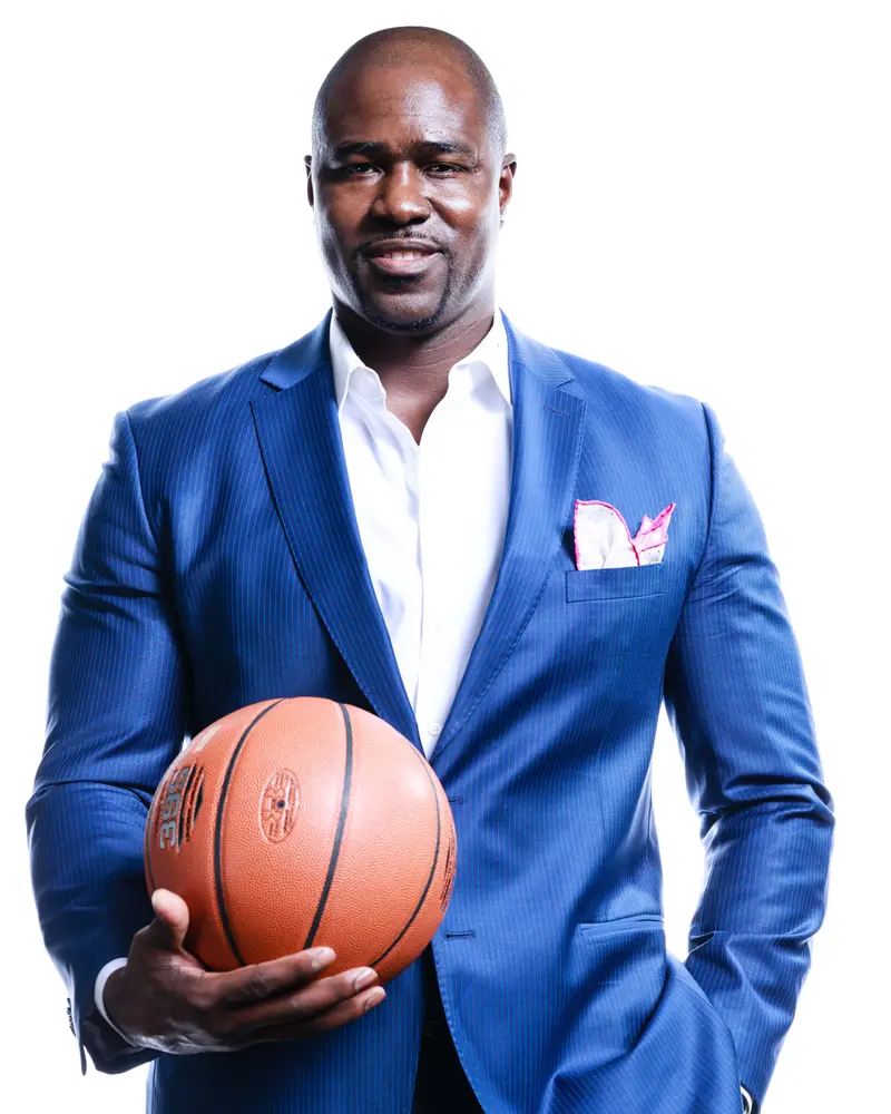 Gary Durrant in a blue suit, holding a basketball