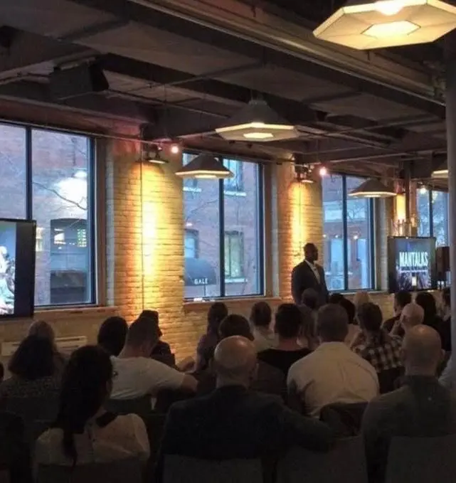 A wide view of an audience listening to Gary Durrant